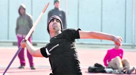 An athlete throws a javelin during an event