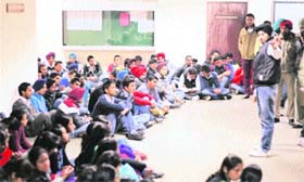 Students sit outside the office of the Dean, College of Agriculture, Punjab Agricultural University, Ludhiana