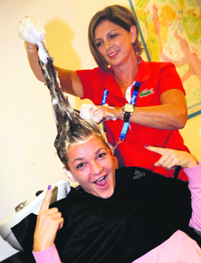 Poland's Agnieszka Radwanska has her hair done in the player beauty bar at the Australian Open.
