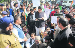 Residents of Colony No. 4 protest outside the DEOs office, Sector 19, Chandigarh, on Tuesday. Tribune Photo: Manoj mahajan