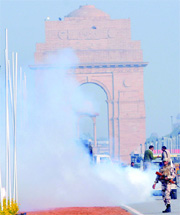 NDMC workers fumigate Rajpath to prepare it for the full-dress rehearsal for the Republic Day parade in New Delhi on Tuesday.