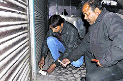 MDDA officials seal a shop in the basement of Abhishek Tower in Dehradun on Tuesday