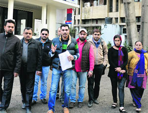 Parents outside the office of the Deputy Commissioner in Ludhiana on Tuesday. 