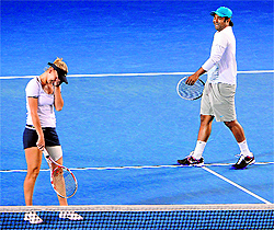 Leander Paes finds something to joke about with Elena Vesnina during their defeat