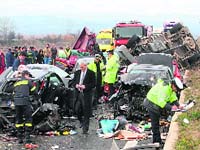 Policemen stand near damaged cars following a 28-vehicle pile-up on the Egnatia motorway in Kleidi, near Athens, on Tuesday