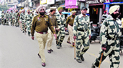 Police personnel carry out a flag march in Amritsar