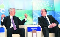 Chairman of Swiss banking giant UBS Axel A. Weber (R) listens to JPMorgan Chase CEO Jamie Dimon during a session of the annual WEF meeting in Davos on Wednesday