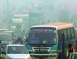 Commuters drive through thick fog in East Delhi on Wednesday