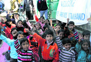 Slum children of the Lakhibagh colony take part in a function on the occasion of the anniversary of Netaji Subhas Chandra Bose at Gandhi Park in Dehradun on Wednesday. 