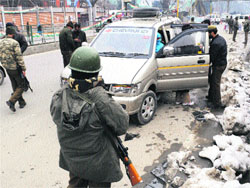 Security personnel check a vehicle at a check point in Srinagar on Wednesday. The security has been tightened in the city ahead of Republic Day. Tribune photo: Amin War