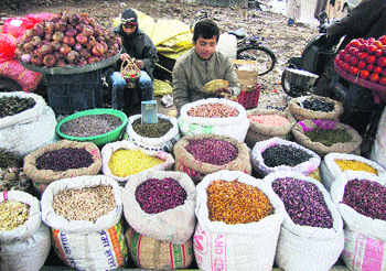 A vendor sells pulses and dry vegetables which have a good demand during the ongoing winter season in Srinagar on Wednesday.