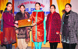 KCW Principal Dr Sukhbir Kaur Mahal (centre) honouring a student during National Youth Week on the college campus in Amritsar on Thursday. 