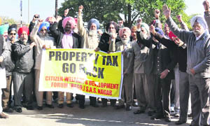 Members of the Citizens Welfare and Development Forum protest against property tax in Mohali on Thursday.