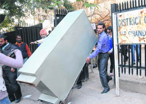 An almirah being taken out from the Sector 17 District Courts to be shifted to the new building at Sector 43 in Chandigarh on Thursday. 