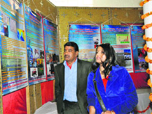 Dr Neelam Goyal shows her poster exhibition to ADC Sujan Singh during Parmanu Urja Jagriti Mahotsava in Bhiwani. 