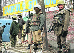 CRPF personnel stand guard at Bakshi Stadium, the venue of the main Republic Day function, in Srinagar on Thursday.  PTI 