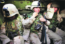 Women soldiers from the US 1st Cavalry join a patrol in Baghdad's al-Jihad quarter.