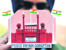 Paper artist Gurpreet Singh, with the help of his model, urges people to take pledge against corruption on the eve of Republic Day, in Amritsar on Friday. 