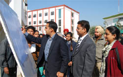 Deputy Commissioner Kamal Kishore Yadav signs on a board as part of a district-level programme hosted at the Baba Farid Group of Institutions to celebrate National Voters Day on Friday. a tribune photograph