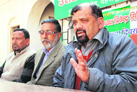 President of the Uttarakhand Kranti Dal Trivendra Singh Panwar and Janmanch chief Rajan Todariya address mediapersons in Dehradun.