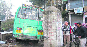 The private bus under the wheels of which three persons were crushed at the bus stand in Nadaun on Friday.