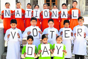 Students of the GGS Public School observe National Voters Day in Mandi on Friday. 