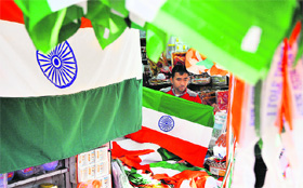  A shopkeeper sells national flags at Purani Mandi market in Jammu on Friday.