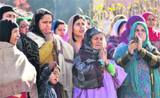 Devotees participate in a ceremony to mark Eid Milad-ul-Nabi celebration in Jammu on Friday.