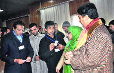 Voter I-cards being distributed among the youth to commemorate the 3rd NationalVoters Day in Srinagar on Friday.