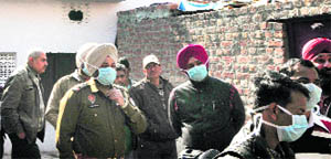 Police officials inspect the site in Sandhu Colony on Saturday. 