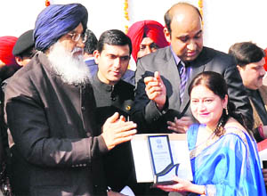 Chief Minister Parkash Singh Badal honours Anjana Gupta, Principal, DAV International School, during the Republic Day function in Amritsar on Saturday. 