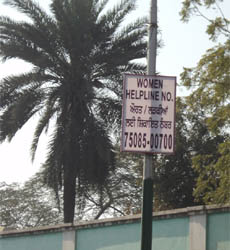 A police hoarding urging women to call the helpline in case of harassment. 