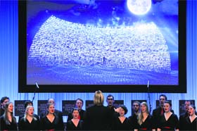The Davos Choir directed by British composer Eric Whitacre performs during the final session of the annual meeting of the World Economic Forum (WEF) in Davos on Saturday