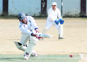 A batsman plays a shot during a match in the 61st Dehradun District Cricket League in Dehradun on Sunday