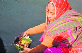 A woman devotee from Rajasthan offers a deep to the Ganga on the occasion of Magh Purnima in Haridwar on Sunday