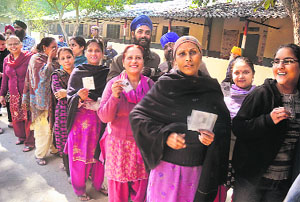 Voters stand in queue to cast their vote at Chakhandi polling station, Tilak Nagar, during the DSGMC elections in New Delhi on Sunday