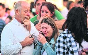 Relatives of victims cry outside a hospital in Santa Maria city on Sunday.