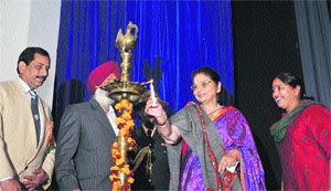 First Lady Usha Vohra lights the lamp at the Republic Day celebrations organised by Department of Youth Services and Sports in Jammu on Sunday. 