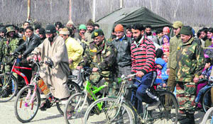Army personnel along with civilians take part in a Chillai Kalaan Mela at Pahalgam on Saturday.