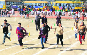 Students parents take part in a race during the annual sports day at Ryan International School in Ludhiana. 