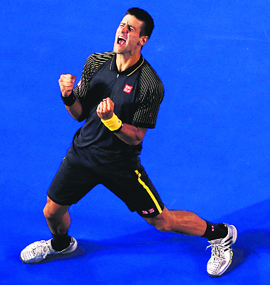 Novak Djokovic celebrates after winning his third straight Australian Open title. Djokovic won 6-7, 7-6, 6-3, 6-2