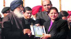Chief Minister Parkash Singh Badal felicitates Mandeep Kaur, principal, Government Girls Senior Secondary School, Mall Road, for her contribution in the field of education on Republic Day in Amritsar