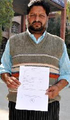 Vinod Kumar with a copy of the complaint filed outside the SSP office in Bathinda. 