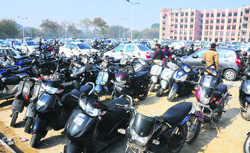 Vehicles parked haphazardly at the parking lot of the new District Courts Complex, Sector 43; and litigants at the Sector 17 courts complex on Monday.