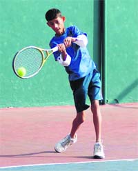 A player in action during a match in the All-India Tennis Talent Series Tournament in Dehradun on Monday.