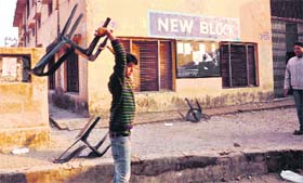 A student breaks a chair during a protest.
