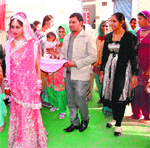 Tulsi and bridegroom Pawan during their marriage at Dera Sacha Sauda in Sirsa on Sunday.