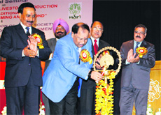 Dr KM Bujarbaruah, Vice-Chancellor of Assam Agricultural University, lights the inaugural lamp at a seminar on the NDRI campus in Karnal on Monday.