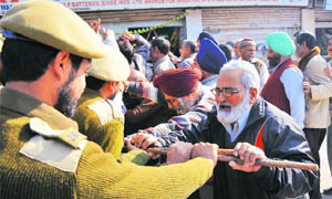 Protesters clash with the police near Dogra Chowk in Jammu on Monday.