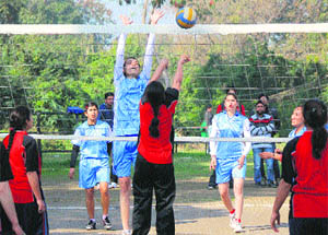 Women spikers in action during the Inter-College Volleyball (women) final at University of Jammu Grounds on Monday. 